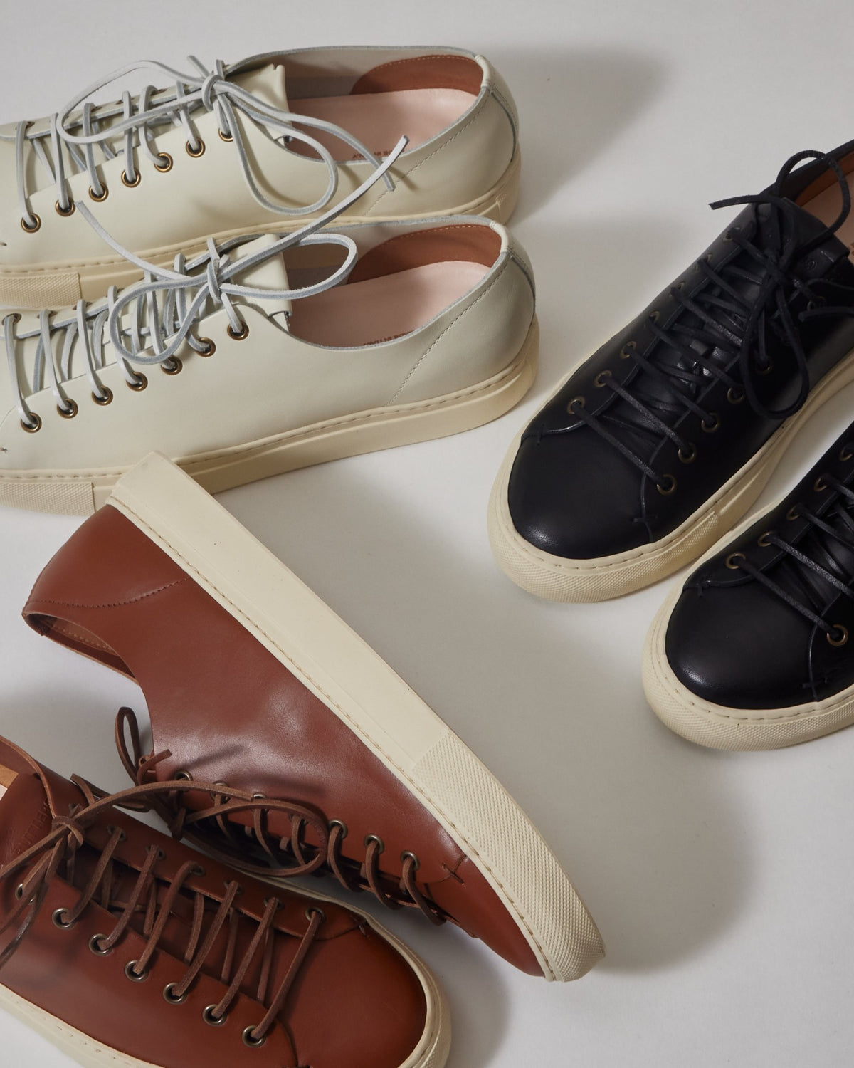 Three pairs of Tanino sneakers in cream, black and brown leather